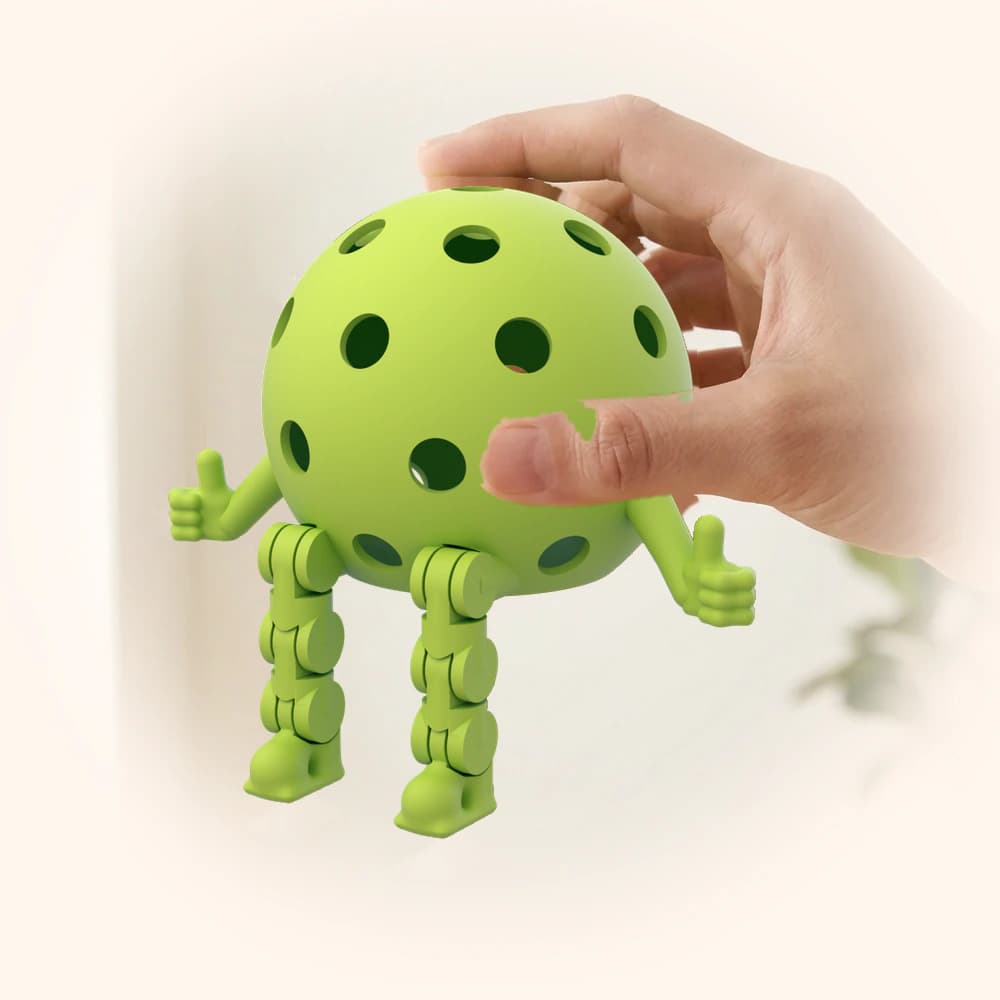 A small Pickleball Dinky held in a hand, showing its actual size